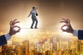 Businessman walking on tight rope Royalty Free Stock Photo