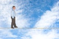 Businessman walking on tightrope