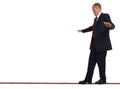 Businessman walking tightrope