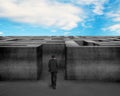 Businessman walking toward to 3D concrete Maze with blue sky Royalty Free Stock Photo