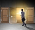 Businessman walking towards open door Royalty Free Stock Photo