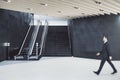 Businessman walking in train station interior with escalator Royalty Free Stock Photo