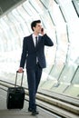 Businessman walking on train station platform and talking on phone Royalty Free Stock Photo