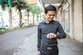 Businessman walking trough sidewalk smiling looking at his wrist watch Royalty Free Stock Photo