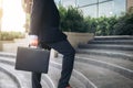 Businessman walking up the stairs and holding a briefcase in han Royalty Free Stock Photo