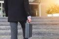 Businessman walking up the stairs and holding a briefcase in han Royalty Free Stock Photo