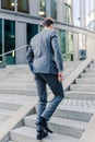 Businessman walking upstairs in an office park Royalty Free Stock Photo