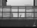 Businessman walks through bridge connecting office buildings