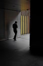 A businessman walks towards a colorful wall