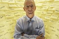 Businessman By Wall Covered In Sticky Notes