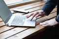 Businessman with watch working on laptop, finger touching the sensor touchpad. Close up Royalty Free Stock Photo