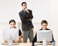 Businessman watching co-workers work Royalty Free Stock Photo