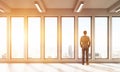 Businessman watching out of panoramic window at big city Royalty Free Stock Photo