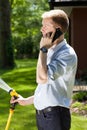 Businessman watering grass