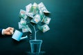 the businessman is watering money tree made by us dollar bills. Business, saving, growth, economic concept. Investors Royalty Free Stock Photo