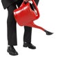 Businessman watering with red can