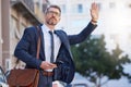 Businessman, wave for cab and taxi in city for transport, morning commute or ride on mobile app. Senior man, hailing or Royalty Free Stock Photo