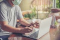 Businessman wear mask working online on laptop