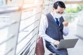 Businessman wear protective face mask and using laptop computer in city Handsome asian man get successful of business Celebrate of Royalty Free Stock Photo