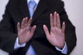 Businessman wearing a black suit, raising both hands, Background city landscape, Anti-corruption concept