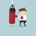 Businessman wearing boxing gloves and punching the punch bag Royalty Free Stock Photo