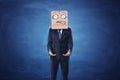 Businessman is wearing cardboard box with drawn shocked face on his head Royalty Free Stock Photo