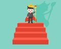 Businessman wearing crown and holding wand as king, stand on red