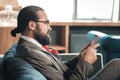 Businessman wearing glasses checking weather forecast on his phone