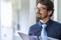 Businessman wearing glasses  holding paper documents folder. Royalty Free Stock Photo