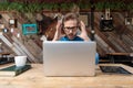 Businessman looking at his laptop fearfully surprised Royalty Free Stock Photo