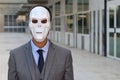 Businessman wearing a horrible mask Royalty Free Stock Photo