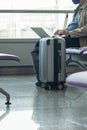 Businessman wearing mask and using laptop at waiting lounge in airport Royalty Free Stock Photo