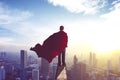 Businessman wearing a red cape in office rooftop