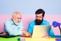 Businessman wearing shirt working with laptop at table. Business men team of two people talk and work together on laptop Royalty Free Stock Photo