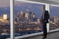 Businessman in an office looking at the view of downtown Los Angeles