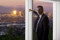 Businessman in an office looking at the view of downtown Los Angeles