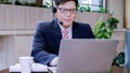 Businessman wearing telephone headset talking to caller in customer services department. Royalty Free Stock Photo