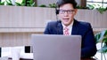 Businessman wearing telephone headset talking to caller in customer services department. Royalty Free Stock Photo