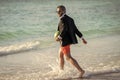 businessman in wet suit at the beach. Summer business dreams. Successful businessman on vacation. Businessman in suit Royalty Free Stock Photo