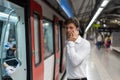 Male manager speaking on smartphone on subway station Royalty Free Stock Photo