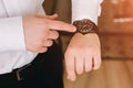 Businessman in white shirt looking at his swiss wristwatch on his hand and watching the time Royalty Free Stock Photo