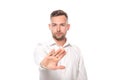 Confident businessman in white shirt showing refusal gesture isolated on white