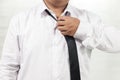 Man in white shirt taking off neck tie Royalty Free Stock Photo