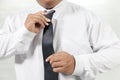 Man in white shirt taking off neck tie Royalty Free Stock Photo