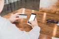 Businessman in white shirt using credit card shopping of Men& x27;s wear online on digital mobile phone Royalty Free Stock Photo