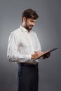 Businessman in white shirt writing on clipboard Royalty Free Stock Photo