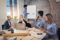 Businessman At Whiteboard Giving Presentation