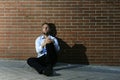 Businessman who lost job lost in depression sitting on city street corner Royalty Free Stock Photo