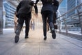 businessman and woman hurry up and running in business city street for rush hour, motion blur background