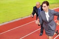 Businessman and woman on running on race track Royalty Free Stock Photo